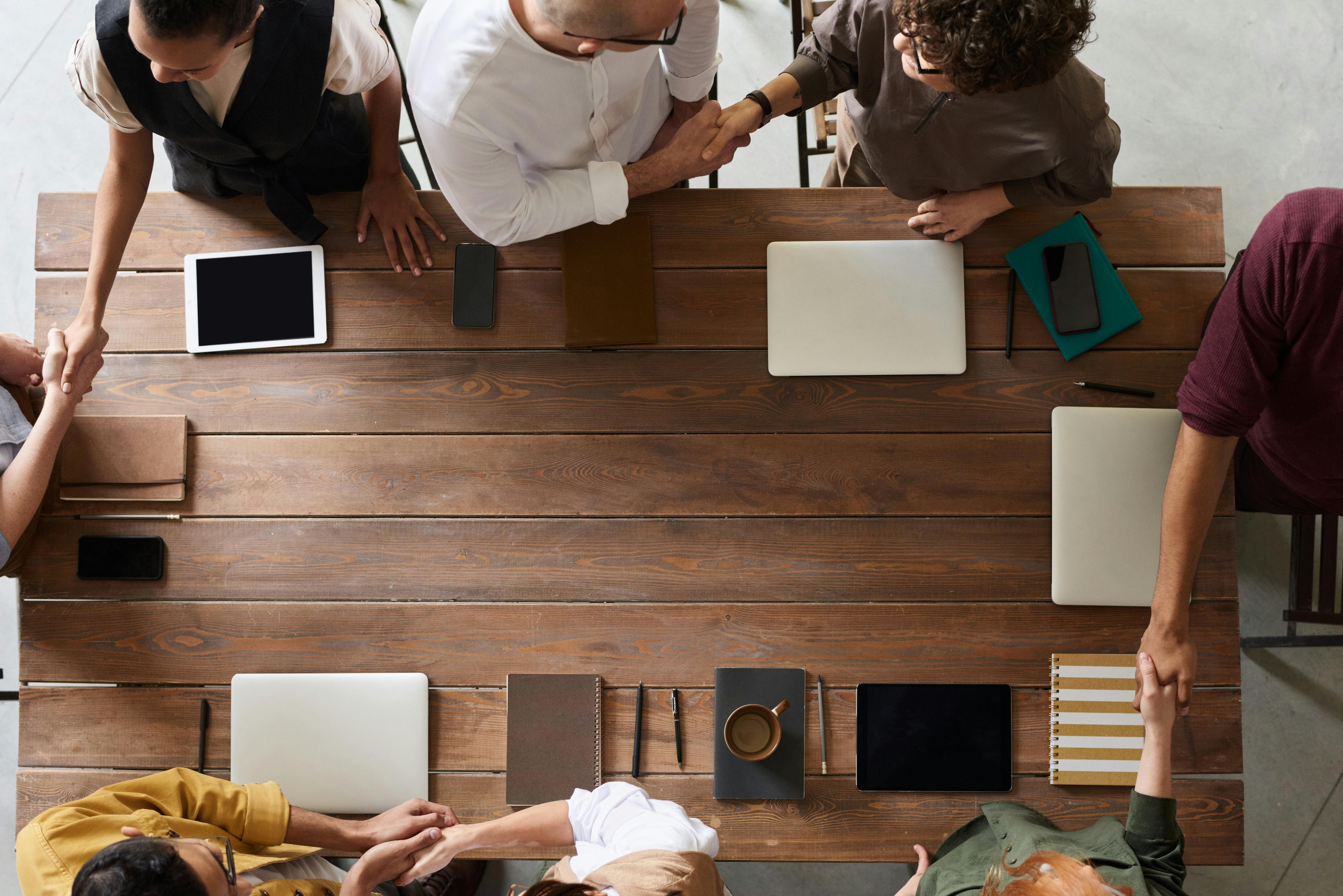 individuals working together around a table for shared purpose.