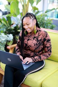 Nonprofit CEO working on laptop computer while seated at desk, representing fractional leadership approach to executive management